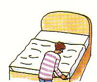 tucking the top sheet under the mattress at the foot of the bed