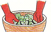 mixing lettuce and cucumber in a salad bowl