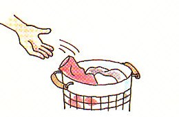 putting dirty clothes in the laundry basket