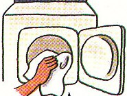 putting laundry into the dryer